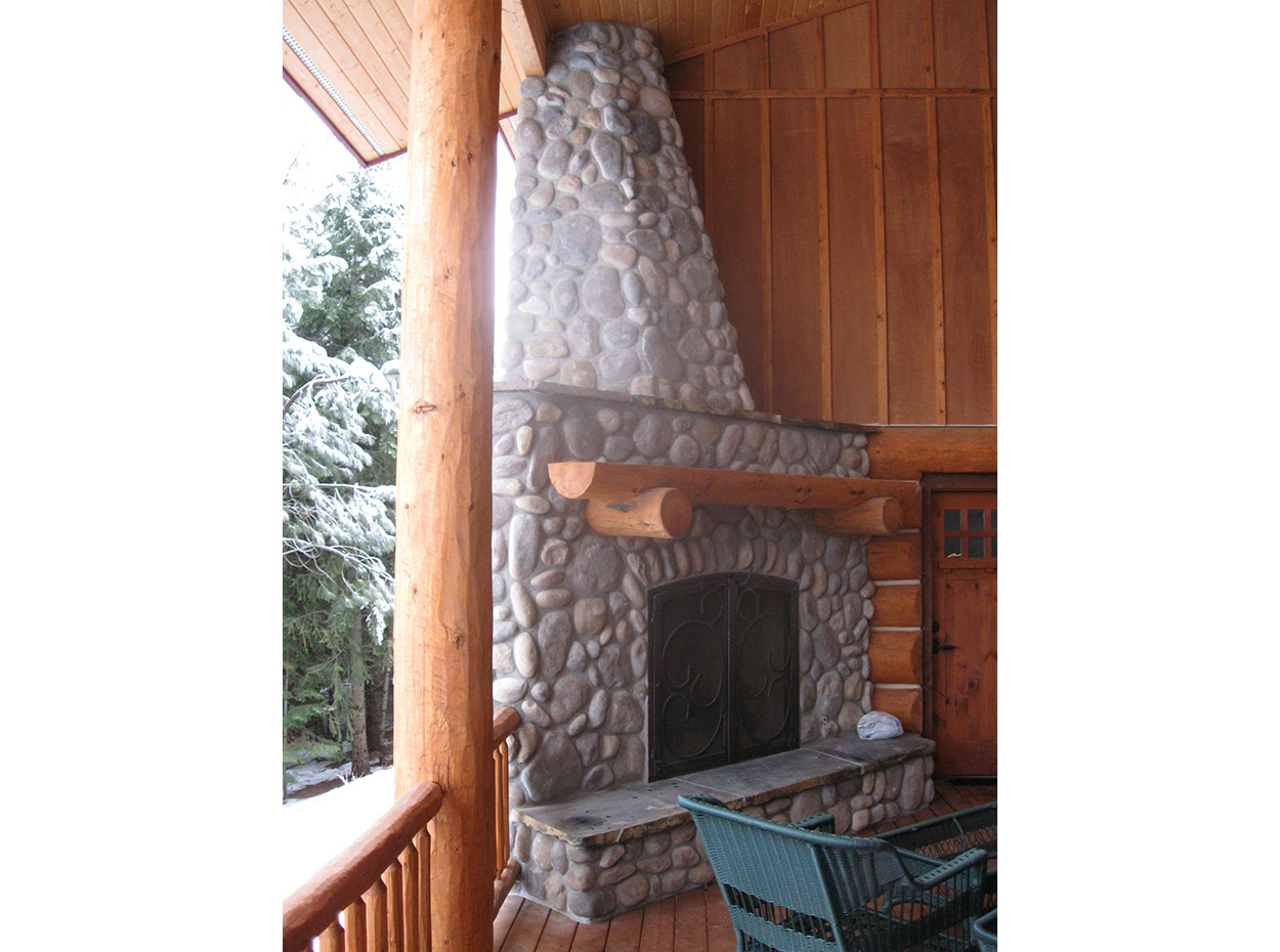 Custom home by Sandpoint Builders in North Idaho, exterior fireplace